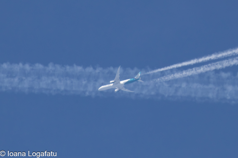 Airplane soaring through a clear blue sky